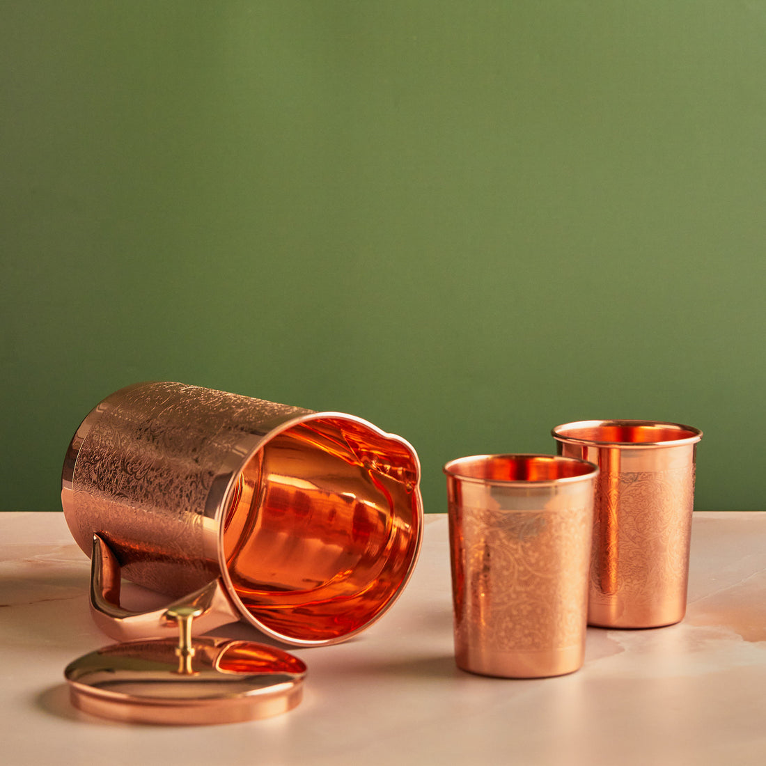 Copper jug set with two glasses showcasing features